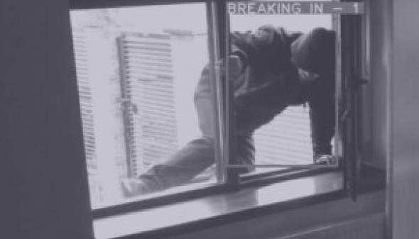 Man Climbing through Window